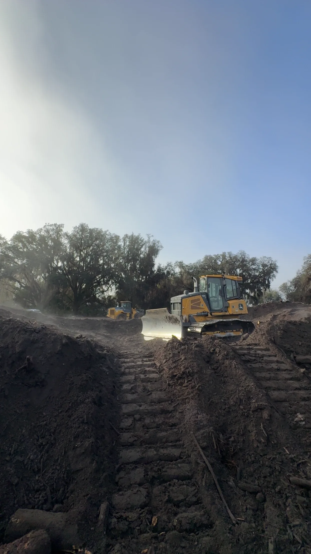 Dozer pushing dirt at first light on a graded site near Starke, Florida